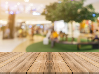 Wooden board empty table blurred background. Perspective brown wood over blur in department store - can be used for display or montage your products.Mock up for display of product.