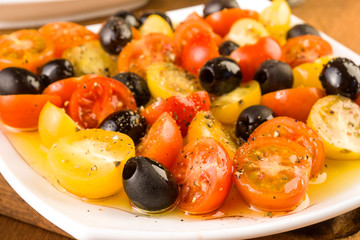 salad with cherry tomatoes and olives on wooden