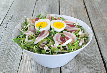 Dandelion salad with eggs and bacon