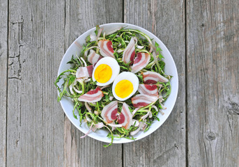 Dandelion salad with eggs and bacon