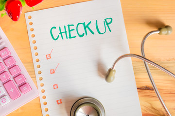 Health Checking cost Concept , top view of paper check list calculator and Stethoscope on wood table , digital effect vintage style