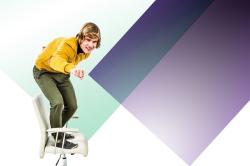 Composite image of happy hipster businessman standing on his chair