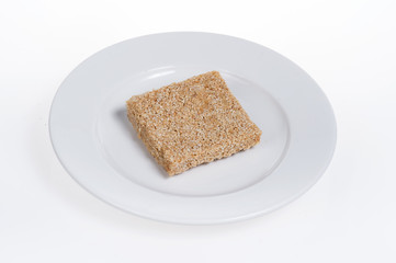 peanut candy on the plate isolated on white background