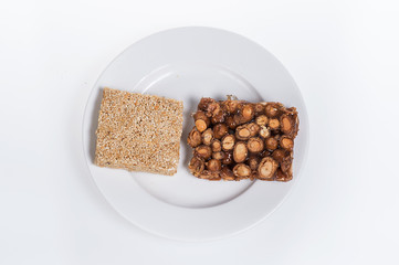 peanut candy on the plate isolated on white background