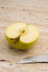 Knife and green sweet delicious sliced apple