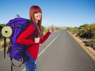 Fototapeta premium Composite image of smiling hipster woman with a travel bag
