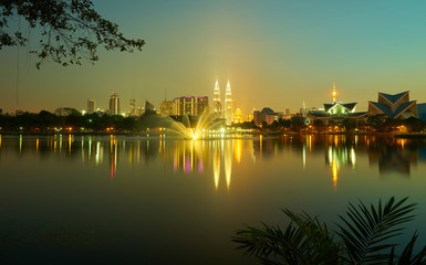 Fototapeta na wymiar Night view of Kuala Lumpur city with stunning reflection in water