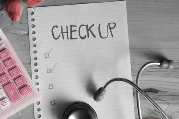 Health Checking cost Concept , top view of paper check list calculator and Stethoscope on wood table , digital effect selective color style