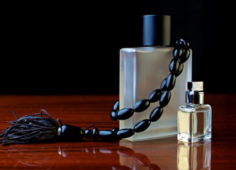 Obraz na płótnie Canvas stylish bottle of male perfume and black jewelery