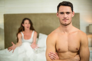 Upset couple sitting on bed 