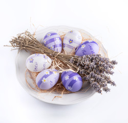Easter background. Dry lavender and easter eggs on a white background.