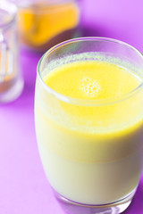 Turmeric with Coconut Milk Drinks and Ghee on Purple Background Good for Beauty and Health, Gives a lot of Energy, Close-up