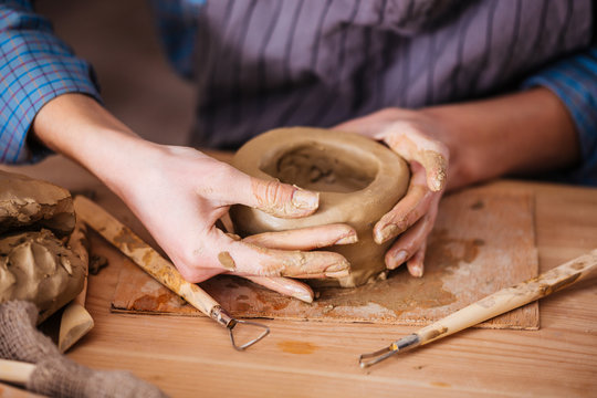 Clay pot making by hands of woman in pottery workshop