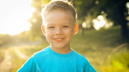 Portrait of smiling boy on sunset - Powered by Adobe