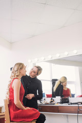 Stylist is penciling eyebrow for young girl