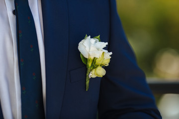 wedding boutonniere on suit of groom