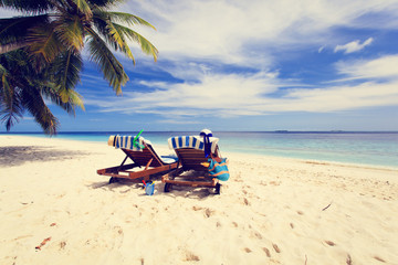 Two chairs on the tropical beach