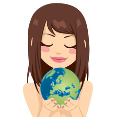 Beautiful young brunette woman holding earth globe showing European continent with her hands