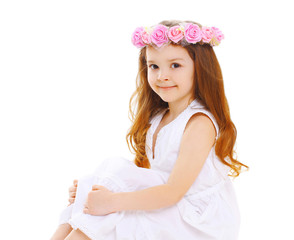 Beautiful little girl child with wreath of flowers on head over