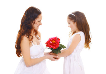 Mothers day, birthday and family concept - daughter gives flower