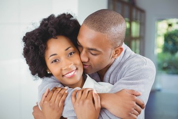 Happy couple hugging in the kitchen