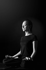 woman practicing meditation against a urban background