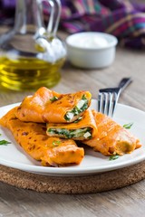 Red tomato pancakes with cheese, eggs, greens, spinach, arugula