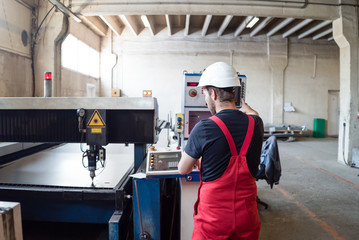 view from behind of a man wearing red overalls