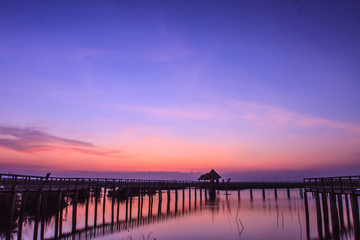 Fototapeta premium Wooden Bridge in lotus lake on sunset time