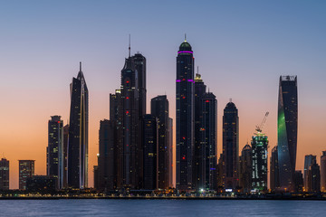 Fototapeta na wymiar Tall Dubai Marina skyscrapers as seen from Palm Jumeirah in UAE. 