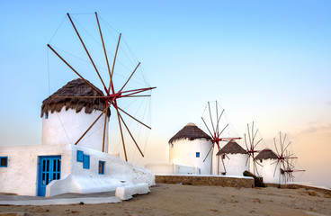 Traditional greek windmills on Mykonos island at sunrise, Cyclad - obrazy, fototapety, plakaty