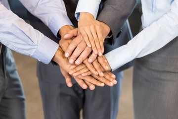Close-up of businesspeople stacking hands