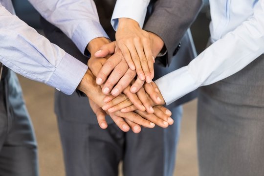 Close-up of businesspeople stacking hands