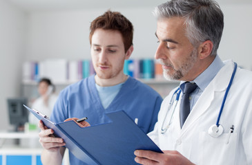 Doctors examining patient's medical records