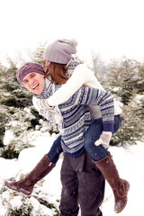 Happy adult couple in park in winter