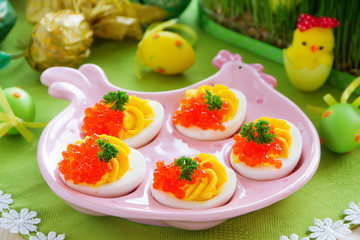 Eggs stuffed with creamy mousse and red caviar.
