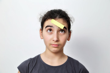 Fototapeta premium Little girl with memo posts on her forehead