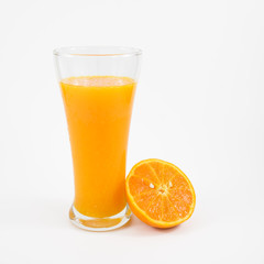 The glass of tasty pure orange juice and fresh orange half for a good healthy.