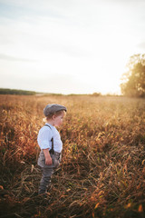 Naklejka na ściany i meble little boy traveler in the field