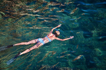 Young woman snorkeling in tropical lagoon