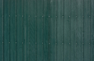 green tin fence with rivets