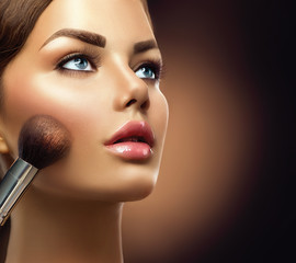 Makeup. Beauty model girl applying make-up  closeup © Subbotina Anna