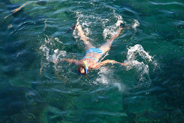 Young woman snorkeling in tropical lagoon