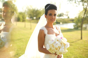 Gorgeous bride with bouquet on wedding day