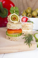finger food with bread, peppers, cucumber, cheese and olives