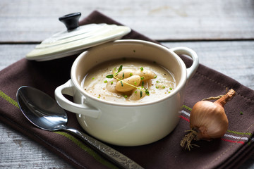Creamy white bean soup on wooden background