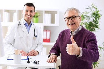 Satisfied old patient with success young doctor