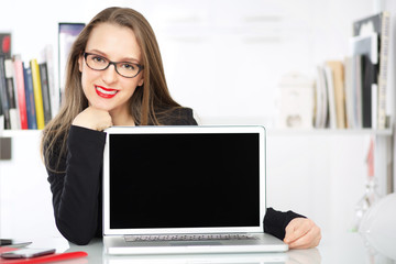 businesswoman showing blank laptop screen