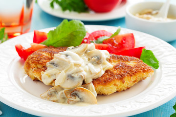 Baked chicken breast with a crispy crust and mushroom sauce.