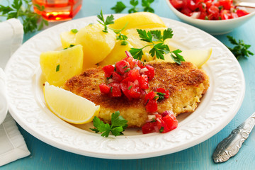 Baked chicken breast with a crispy crust, with boiled potatoes and tomato salsa.